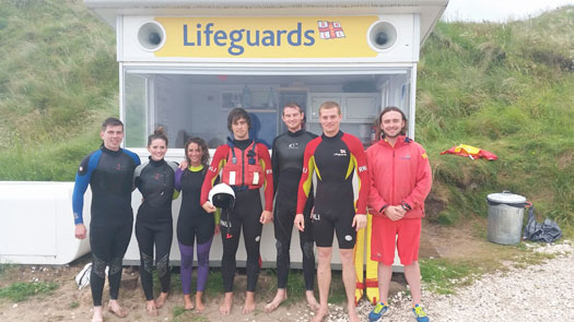 RNLI lifeguards with paddle boarders at Whiterocks