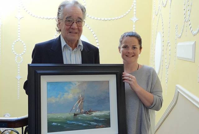 Artist Brian Byrnes and Maedhbh Murphy, archivist of the Royal College of Surgeons in Ireland, with the artist’s new painting envisaging how Sir Thomas Myles’ Chotah, one of the Irish gun-running vessels of 1914, might have looked with a steam-driven auxiliary engine fitted. Sir Thomas Myles was President of the RCSI from 1900 to 1902