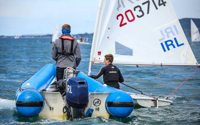 Radial sailor Johnny Durcan from Royal Cork alongside his coach–boat before a race at this summer's Laser Radial Youth Worlds in Dun Laoghaire. Durcan is among the talented Junior All Ireland Championships line–up in Schull, West Cork tomorrow 