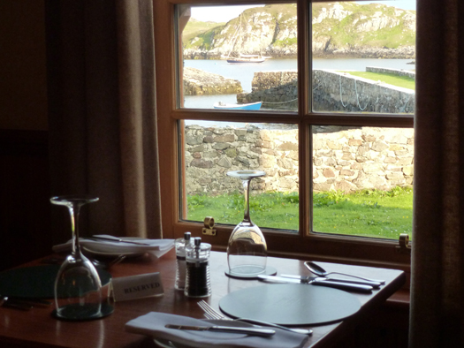 A MacDonald's with a difference – Ainmara serene in the evening sunshine at Poll an Tigh-Mhail, seen from the dining room in the Rodel Hotel. Photo: W M Nixon  