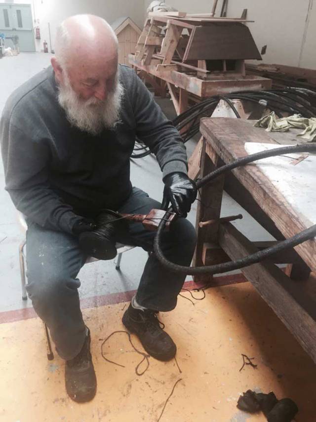 In time-honoured style, Liam O’Donoghue in the Ilen Boat Building School in Limerick parcels and serves the final pieces of Ilen’s wire rigging using his traditional serving board