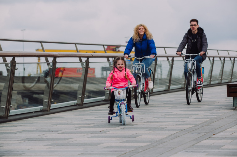 Cyclists take in the Maritime Mile in Belfast Harbour with the backdop of H&amp;W shipyard. Remember to practise social-distancing &amp; stay 2 metres apart from those not in your household.