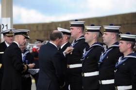 Minister of State with special responsibility for Defence Paul Kehoe presenting the new international operational service medals to Irish Navy Service personnel