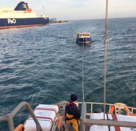 The all-weather lifeboat Dr John McSparran tows the stricken motorboat to Larne Harbour