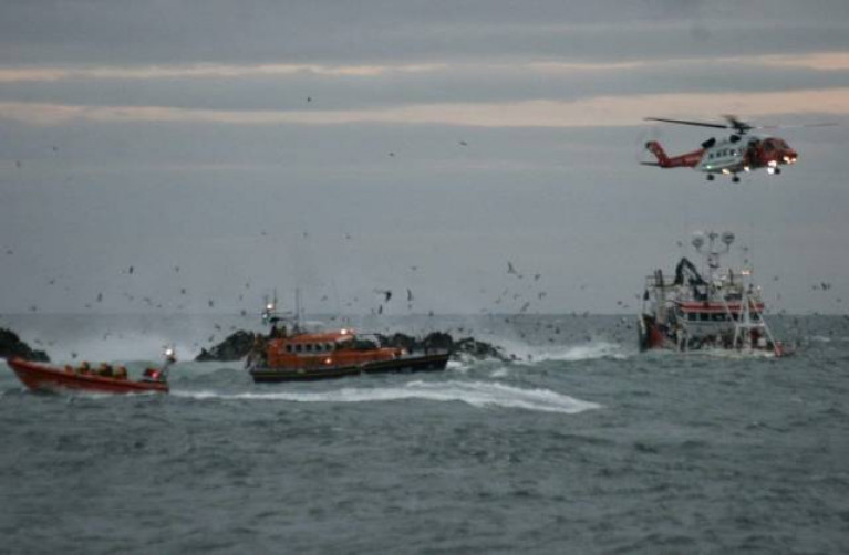 Portaferry and Newcastle RNLI crews from Portaferry and Newcastle work with Irish Coast Guard helicopter Rescue 116 to rescue the crew of the grounded fishing boat at Ardglass last October