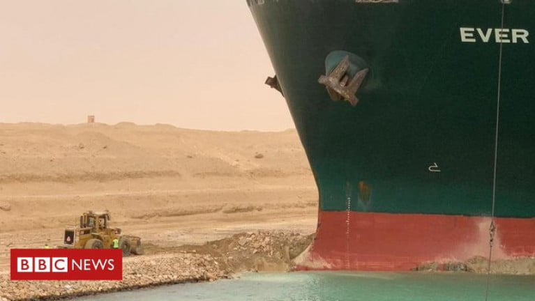 Owner of the enormous containership, Ever Given (above bulbous bow) wedged across Suez Canal apologises for major disruption to international trade route. The giant ship is causing a traffic jam in one of the world's busiest waterways