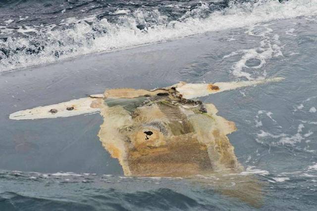 Photograph of Cheeki Rafiki's upturned hull taken by crew of USS Oscar Austin on 23 May 2014