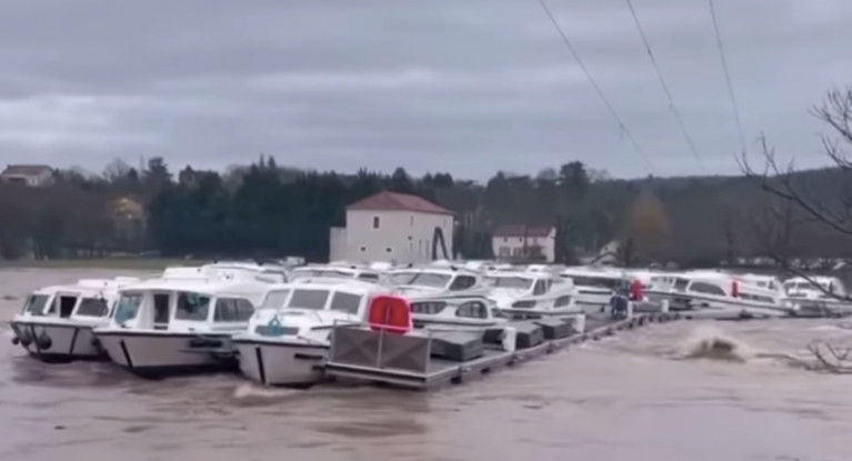 Cruisers are dragged en masse from their moorings in the raging floodwaters