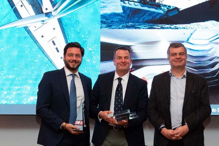Mark Mills of Mills Design (pictured centre) accepts his award in Monaco