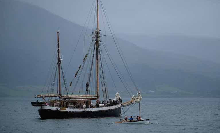 TS Britta waits in Carlingford Lough as the Drontheim rowers come ashore with a cargo of chocolate