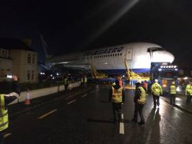 The Boeing 767 is transported across the road from the beach at Enniscrone to the new glamping site