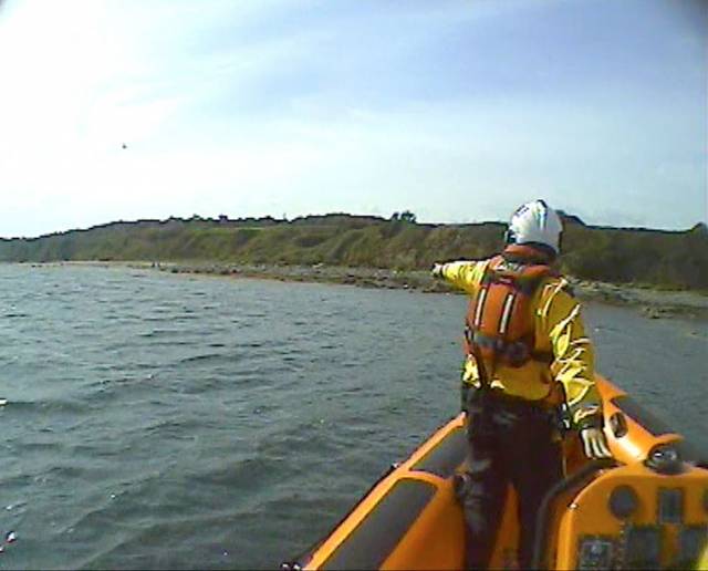 A volunteer crew member with Skerries RNLI spots a garda waving from shore