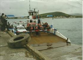 Concerns over the future of the Valentia Island car ferry service which Afloat adds is operated by the 1963 built God Met Ons III. The vessel is at Reenard Point on the inaugural day of operations in July 1996 with the backdrop of Knightstown, Valentia Island.