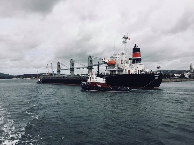 Ship Snapshot: Bulk-carrier Farania loaded with animal feed from Romania arriving with tugs, Mourne Shore (at stern) when approaching Warrenpoint Port.
