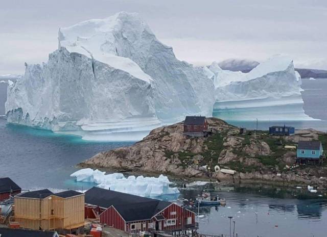 The huge iceberg in Greenland has drifted close to a village on the western coast, threatening residents in case it splits resulting in waves swamping homes.