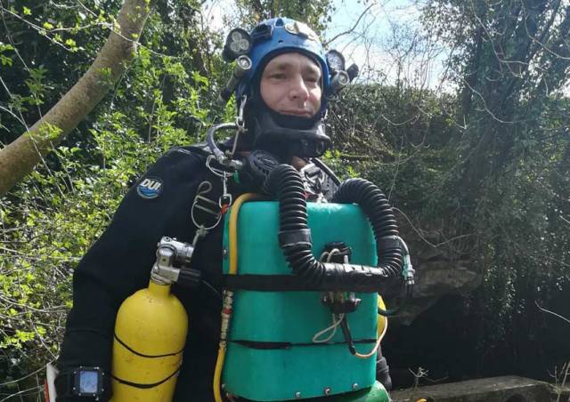 Jim Warny suited up for a subterranean dive near his home in Ennis this past April