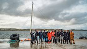 Vestas 11th Hour Racing’s delivery crew show off their boat’s jury-rigged mast before setting sail from the Falklands