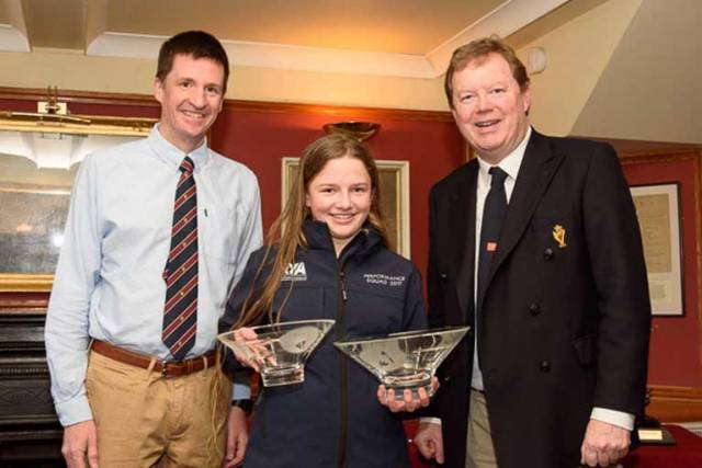 Erin Mcilwaine, winner overall and first girl of the Topper Winter Championships at Royal Cork. Erin is photographed with Pat Horgan Class Captain Toppers RCYC (left) and Admiral John Roche who presented the prizes. Scroll down for photo galler