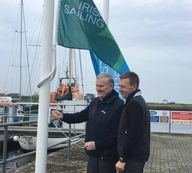 Irish Sailing President Jack Roy (left) raises the IS Training Centre flag at KIlrush Marina watched by Training Centre Principal and Marina Manager Simon McGibney