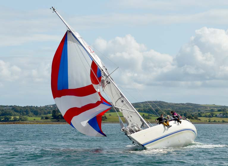 A Sigma 33 crew get to grips with a spinnaker while racing on Strangford Lough in 2019 