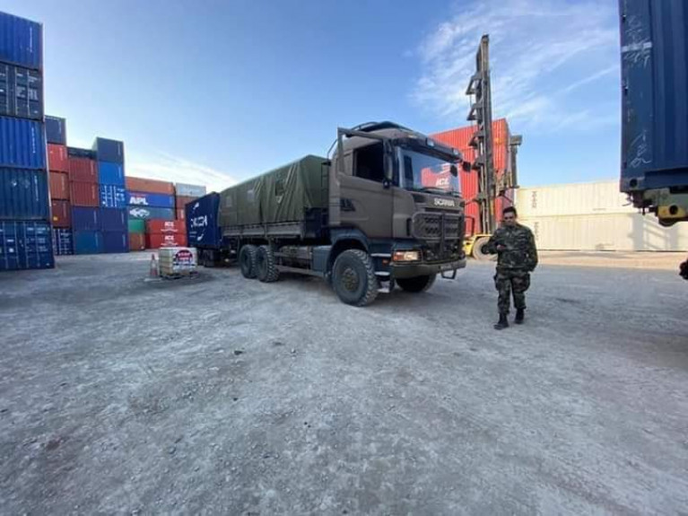 Óglaigh na hÉireann personnel collecting medical supplies for delivery to Irish Hospitals, supporting the HSE in the fight against COVID-19. AFLOAT adds the Irish Army truck is seen with a shipping container trailer at a port&#039;s lo-lo container terminal.  