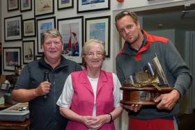 Cian McCarthy (right) winner of the Bertoletti Trophy, receives his prize from Patricia Bertoletti and Kinsale Yacht Club Commodore David O&#039;Sullivan