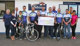 Ring of Kerry cyclists with their cheque for Fethard RNLI