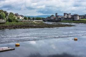 River Shannon flowing past King John’s Castle in Limerick, where Jim Kennedy and company will complete their recreated ‘paddle for peace’