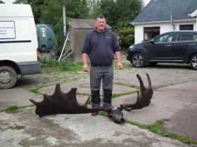 Raymond McElroy with the remains of the Irish elk he fished out of Lough Neagh on Wednesday