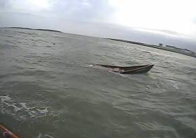 The capsized currach off Skerries