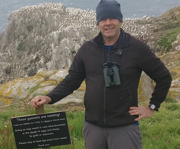 Professor John Quinn with the Gannet colony sign on the Great Saltee Islands