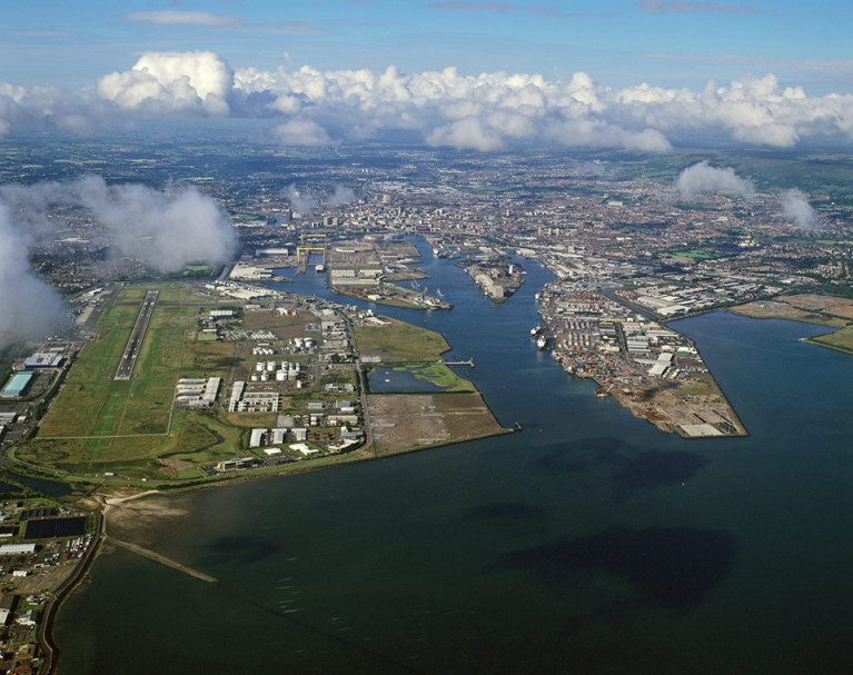 In this aerial view of Belfast Harbour&#039;s port estate note alongside on the left is the George Best Belfast City Airport, one of two that serve the Ulster capital. 