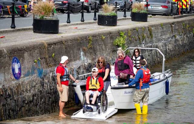 Enable Ireland participants Callum O'Mahony from Douglas with volunteers taking part on board the Wheelyboat at the Watersports Inclusion Games 2019