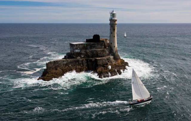 The 48ft American sloop Carina (Rives Potts) rounding the Fastnet Rock in 2011, when she won her class. A successful veteran of the 1979 Fastnet Race, Carina made her debut in the 1969 race, and today she starts in her Golden Jubilee Fastnet Race