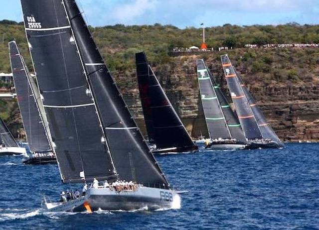 “The Race of the Year”. Shortly after the start of the RORC Caribbean 600, with the big boats hard on the wind and closing the cliffs of Antigua. George David’s Rambler 88 (foreground) was to go on to take line honours, but ahead of her at this stage are Bella Mente (US 45) and Proteus, locked together right in on the land, with Bella Mente about to call for water and tack with control over Proteus. 