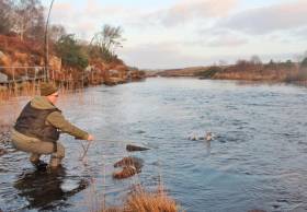 Michael McCann about to land the first salmon of the season on the Lackagh River in Co Donegal