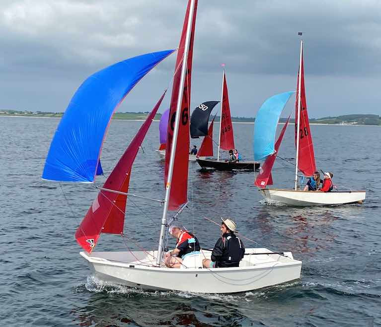 "The Hat" in his hot glass boat…Caolan Croasdell and Fiona Drayne (Lough Ree YC) on their way to winning the Mirror Nats, with Chloe & Fionn Murphy (also Lough Ree and fourth overall) close aboard, and the black-hulled Blue Away (David Evans & Jack Draper, Sligo YC, 5th overall) chasing them both