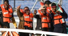 Some of the 49 migrants who had been stranded on the ‘Sea-Watch 3’ react towards the media as they disembark from a Maltese patrol boat yesterday.