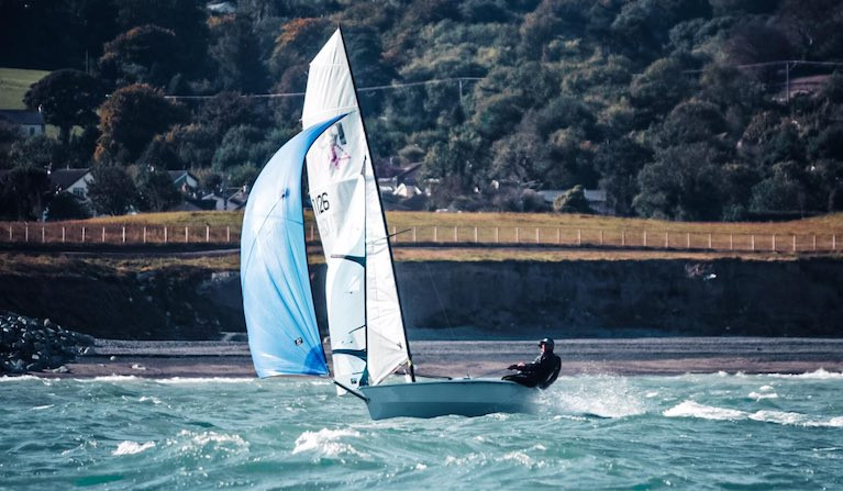 An RS400 dinghy planing on a reach in great breeze at Greystones Bay, County Wicklow