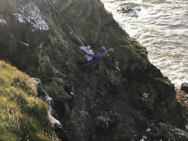 The teenage girl is lifted to safety by Coleraine Coastguard’s rope rescue specialist