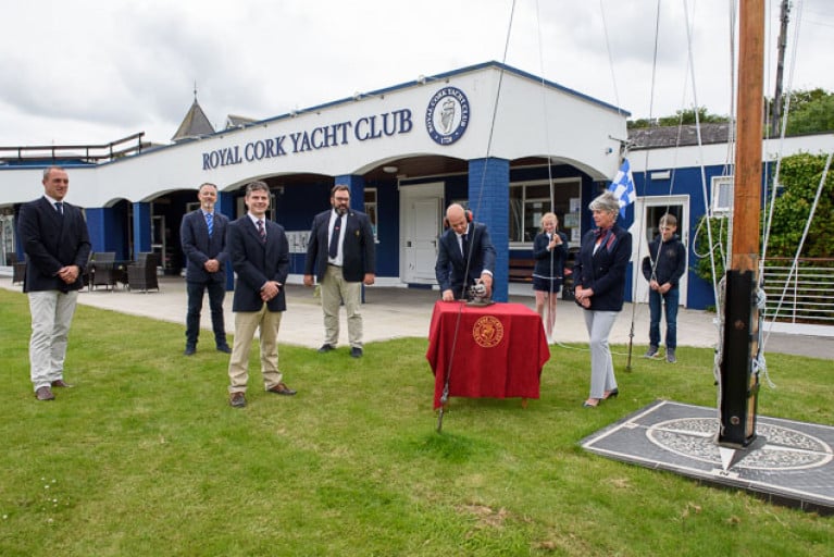At the socially-distanced noonday ceremony at Royal Cork Yacht Club on Sunday to consign Volvo Cork Week 2020 to history were (left to right) Kieran O’Connell (Vice Admiral RCYC and Chairman Volvo Cork Week 2020), George Mills (Johnson &amp; Perrott and Volvo), Ross Deasy (Director of Racing – Keelboats Cork300), Colin Morehead (Admiral RCYC &amp; Chairman Cork300), Daragh Connolly (at signal cannon, Rear Admiral Keelboats RCYC), Megan O’Sullivan (Optimist sailor, RCYC), Annamarie Fegan (Rear Admiral – Dinghies RCYC) and Harry Moynan (Optimist sailor RCYC). 