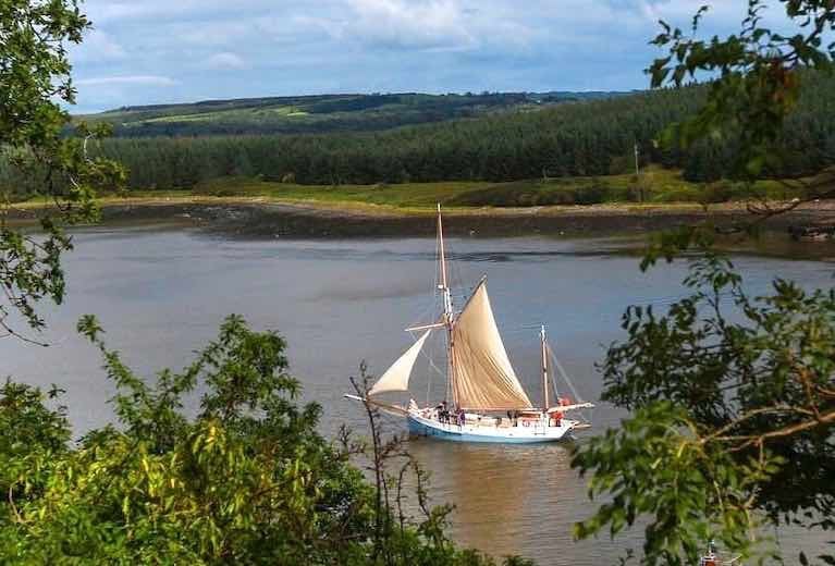 Ilen departs Foynes, on passage for Kilronan in the Aran Islands. Conor O'Brien – Ilen's designer in 1926 – ensured that all his major voyages essentially started from Foynes, his home port where he lived on Foynes Island