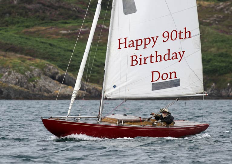 Telling it like it is: Glandore greetings for 90-year-old Don Street on Saturday as he apparently sails vintage Dragon Gypsy single-handed………..
