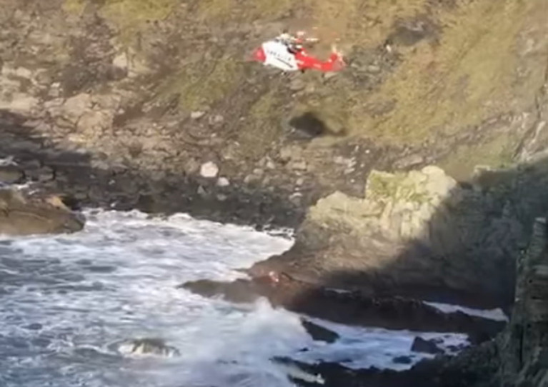 Rescue 117 lowers its winchman amid high winds off the Old Head of Kinsale on Sunday 27 December