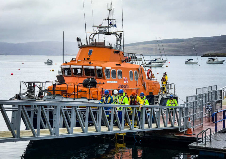 Tobermory RNLI crew and local HM Coastguard volunteers help bring the injured man ashore