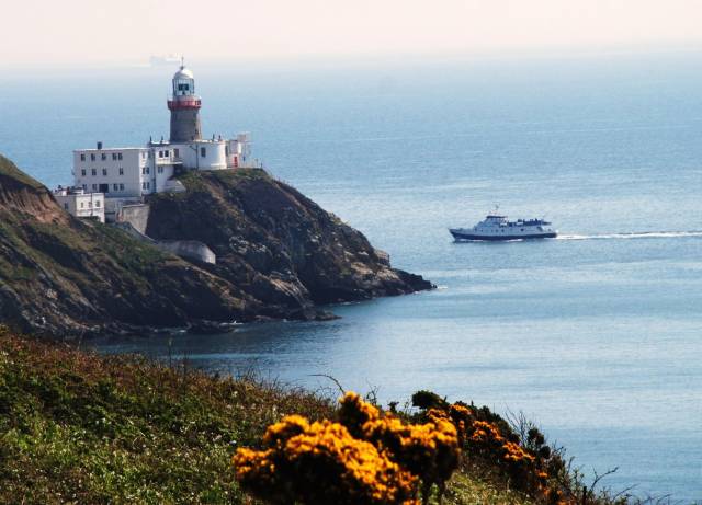 Irish Lights which operates and maintains marine aids to navigation (AtoN's) among them the iconic Baily Lighthouse, Howth Peninsula on Dublin Bay. AFLOAT adds this file photo includes the former fast-ferry HSS Stena Explorer (on hazy horizon left of lantern) during a crossing from Holyhead, Wales and bound for Dun Laoghaire Harbour. In the foreground is Dublin Bay Cruises excursion vessel St. Bridget heading for Howth Harbour. 