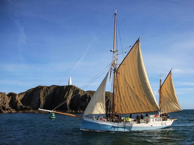 The Ilen as she is today, fully restored and sailing into port past the Baltimore Beacon before departing for her passage to Limerick. Back in 1952, she was far from being in the same excellent order when Pat McCarthy, originally of Bantry, managed to deliver her from the Falkland Islands to Chile for a much-needed complete refit. 