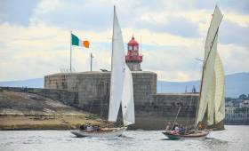 The essence of the Volvo Dun Laoghaire Regatta. The Dublin Bay 24 Periwinkle (built 1947) and the 1897 classic cutter Myfanwy approaching the harbour mouth racing neck-and-neck in idyllic summer sailing conditions in July 2017