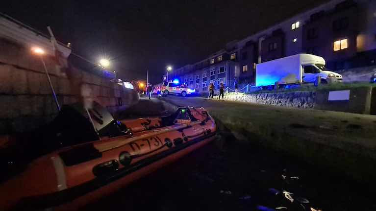 RNLI inshore lifeboat crew and Irish Coast Guard on scene at Bullock Harbour, Dalkey on Dublin Bay