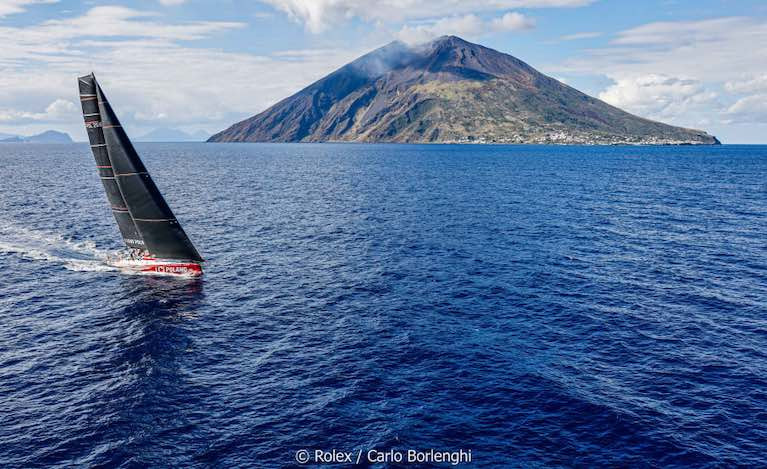 The Rolex Middle Sea Race mono-hull leader, I Love Poland, a Volvo 70, comes past Stromboli at a safe distance not to avoid volcanic eruptions, but to stay out of the notorious inshore calms